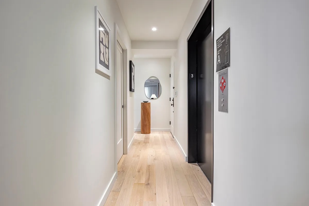 Greenwood Heights — narrow rooftop terrace with pale stone pavers alongside black-framed windows and a clear sky — image 2 of 16