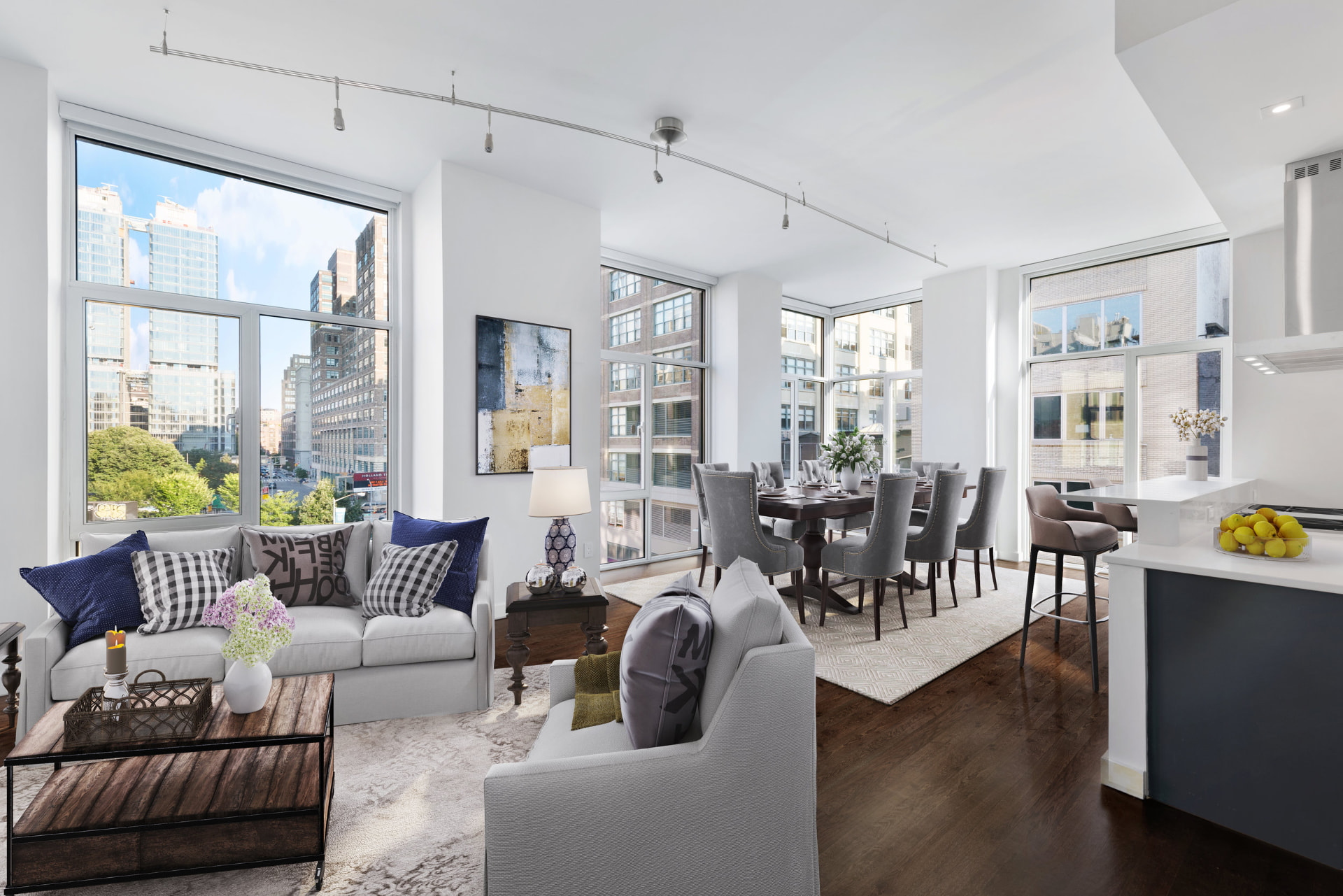 Tribeca II — dining room with a set table and upholstered chairs beside tall city-facing windows, with white built-in shelving and dark hardwood flooring — image 8 of 14