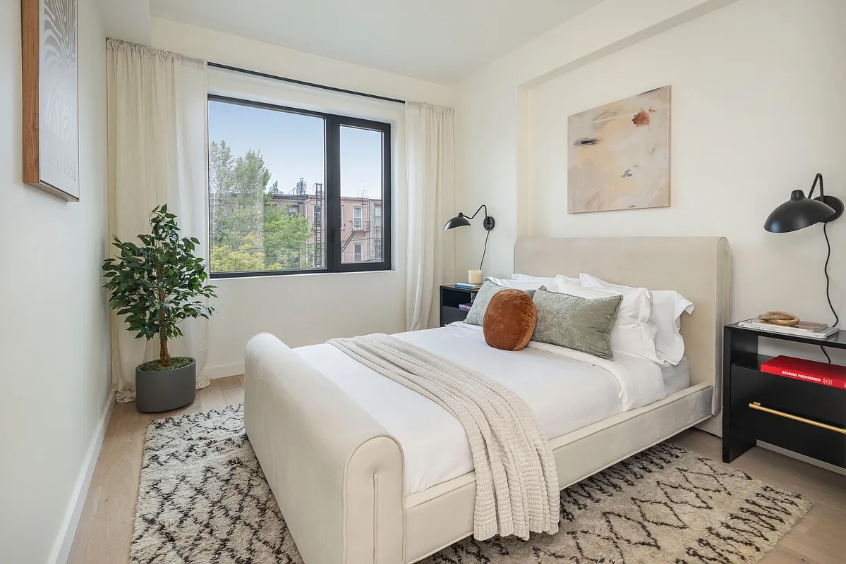 Greenwood Heights — narrow rooftop terrace with pale stone pavers alongside black-framed windows and a clear sky — image 6 of 16