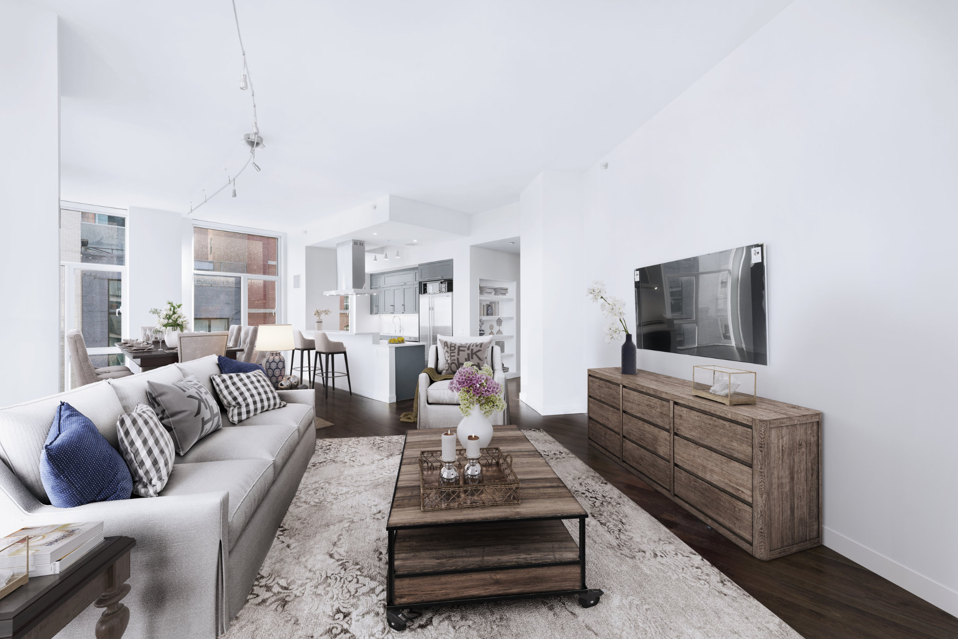 Tribeca II — dining room with a set table and upholstered chairs beside tall city-facing windows, with white built-in shelving and dark hardwood flooring — image 11 of 14
