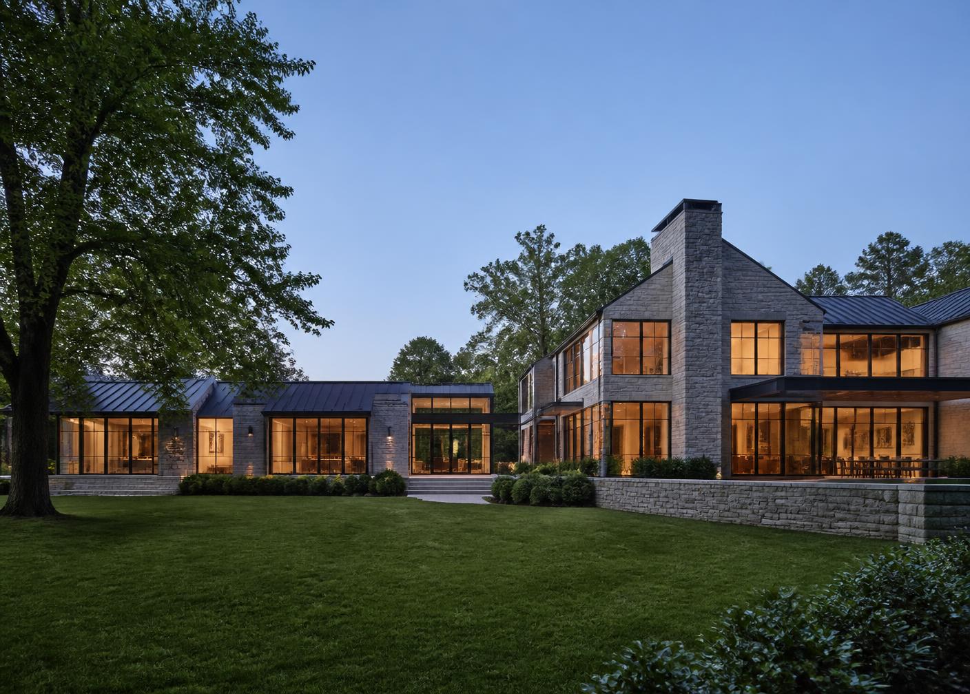Stone and glass Westchester estate at dusk built by Home Evolutions Corp